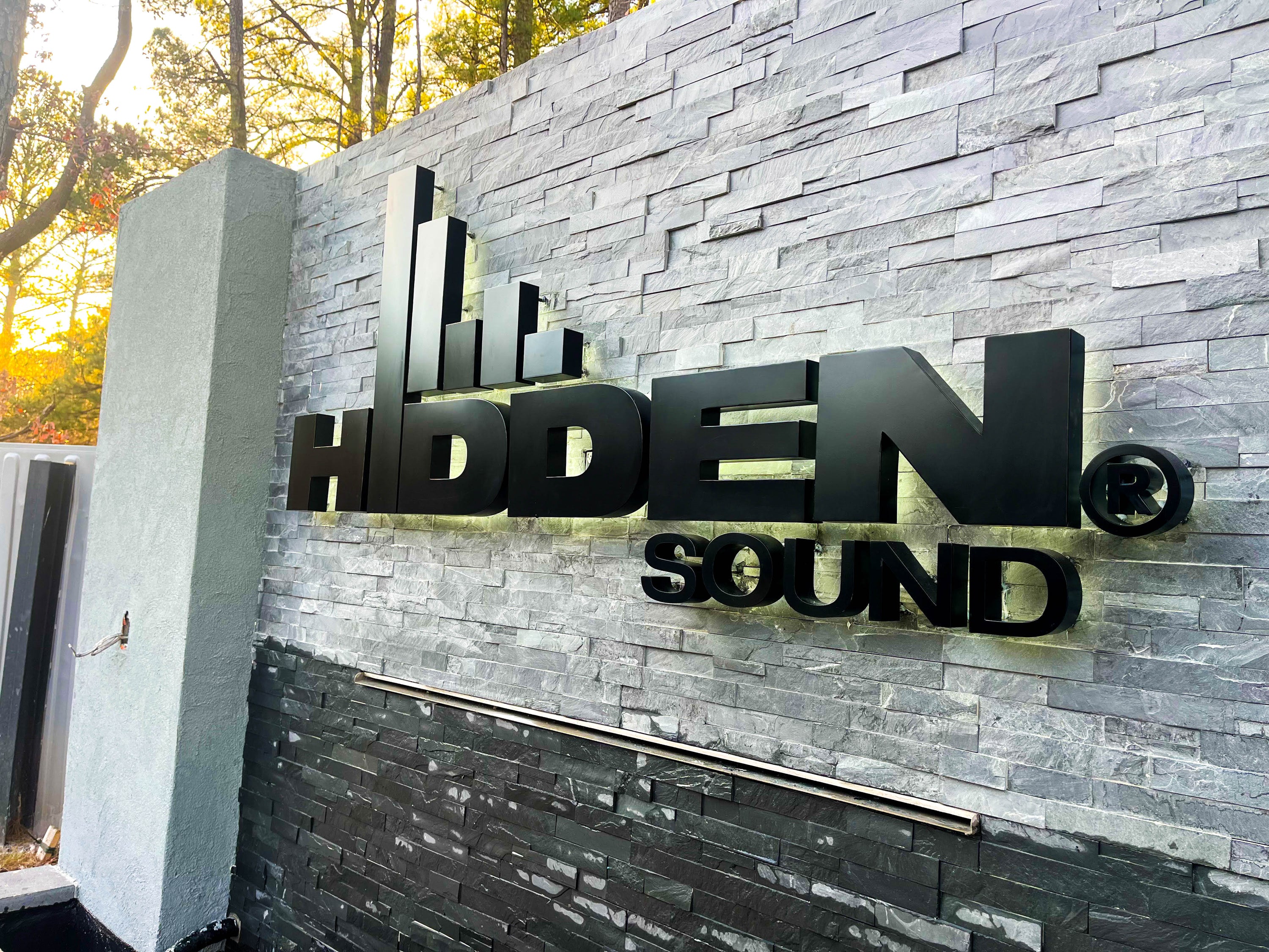 hidden sound backlit welded channel letter stone sign